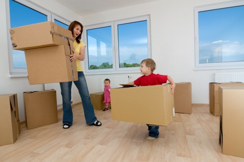 Local removal team handling furniture in a West Ham flat