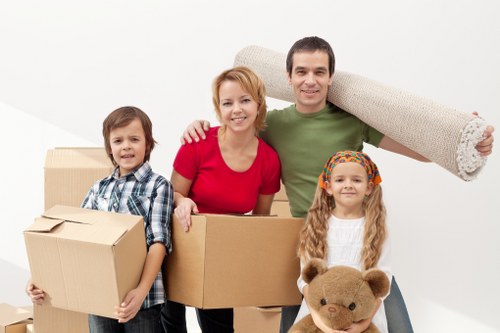 Team handling office furniture and equipment carefully