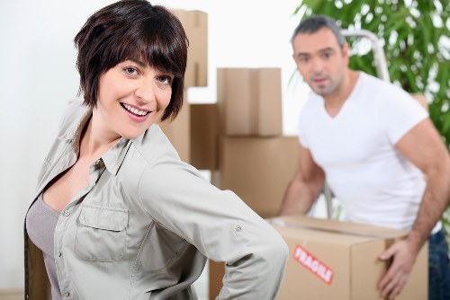 Professional movers loading boxes into a removal van in Westham